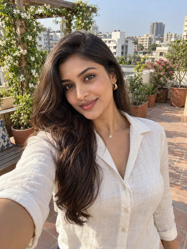 AI example of an adult Indian woman in an ivory blouse on a city rooftop garden